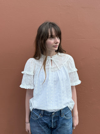 women wearing cream embroidered top