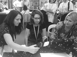 women buying prints at pv