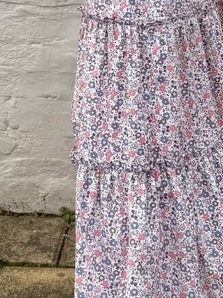 Close-up of ruffle trim and floral cotton fabric on ethically made UK skirt.