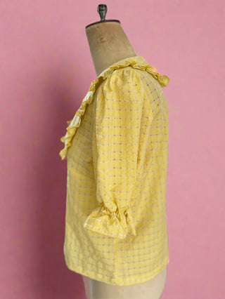 Studio shot of a sustainable collar blouse on a mannequin, emphasizing its minimalist design and eco-conscious fabric, proudly made in the UK.