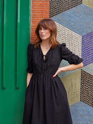 women stood outside wearing black dress detail