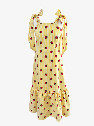 Front view of The Mila Dress – yellow stripe cotton sundress with embroidered strawberries and bow shoulder ties, handmade in the UK
