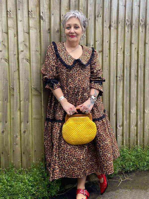 The Well Worn woma wearing leopard print dress