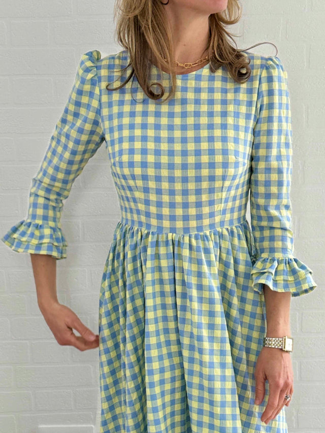 The Well Worn woman wearing gingham dress details