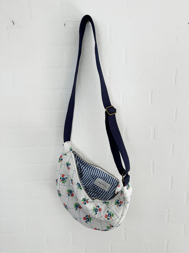 The Well Worn vintage fabric cross body bag hanging on wall