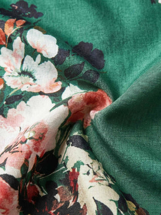 Close-up of floral fabric with green background