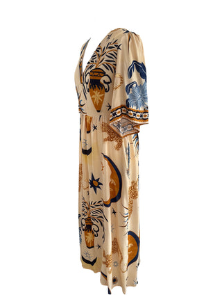The Seraphina Dress in celestial print with flutter sleeves, a v-neckline, and a graceful silhouette, perfect for day-to-night wear.