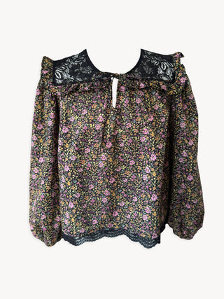 Floral blouse with lace details on a white background