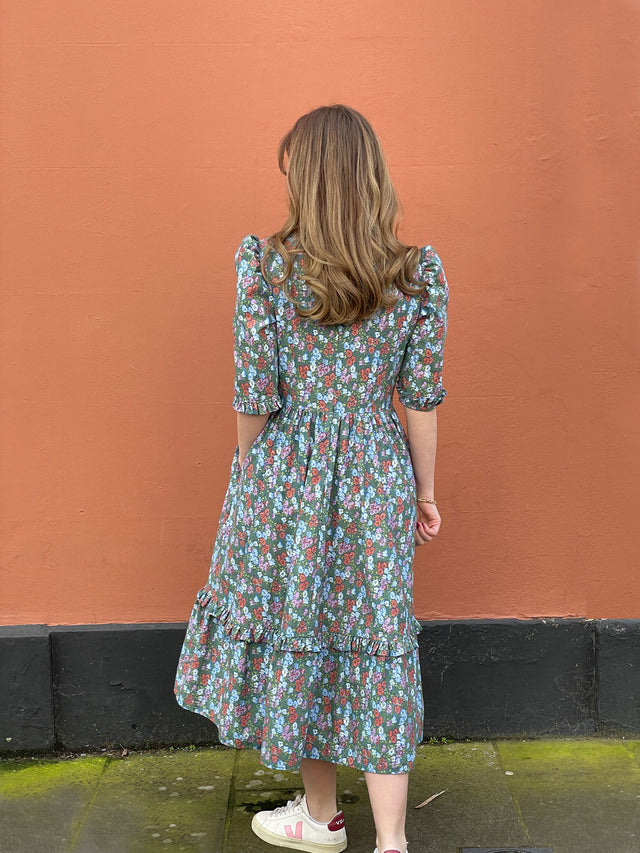 The Well Worn back of women wearing cotton floral dress by wall