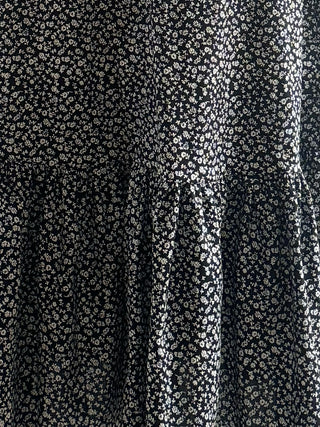 Close-up of black fabric with small white floral pattern made uk