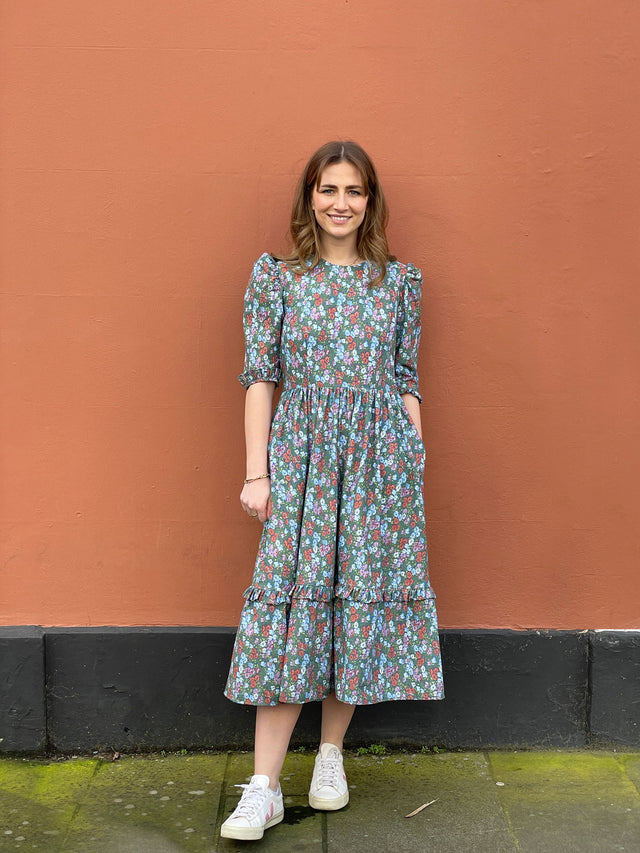 The Well Worn women wearing cotton floral dress by wall