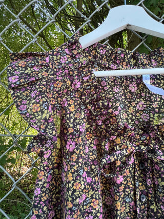 detail floral blouse chain link fence