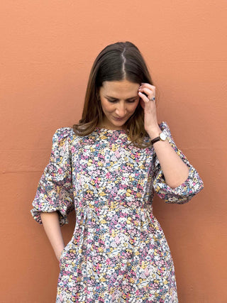 Slow fashion floral dress with ruffled elbow-length sleeves and timeless silhouette.