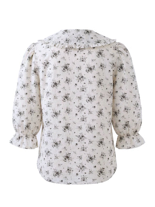 Floral patterned blouse on a white background