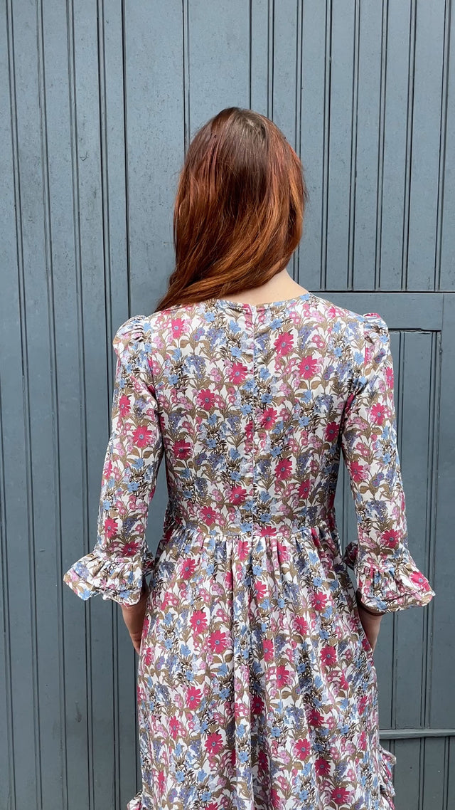 The Well Worn woman wearing floral dress