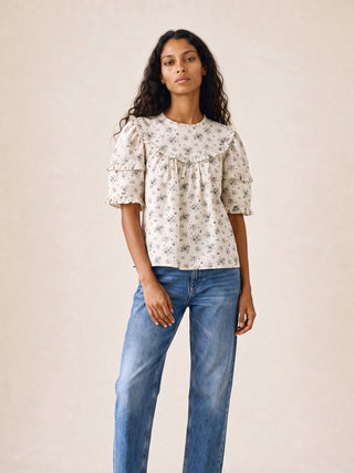 women wearing floral ruffle top in studio