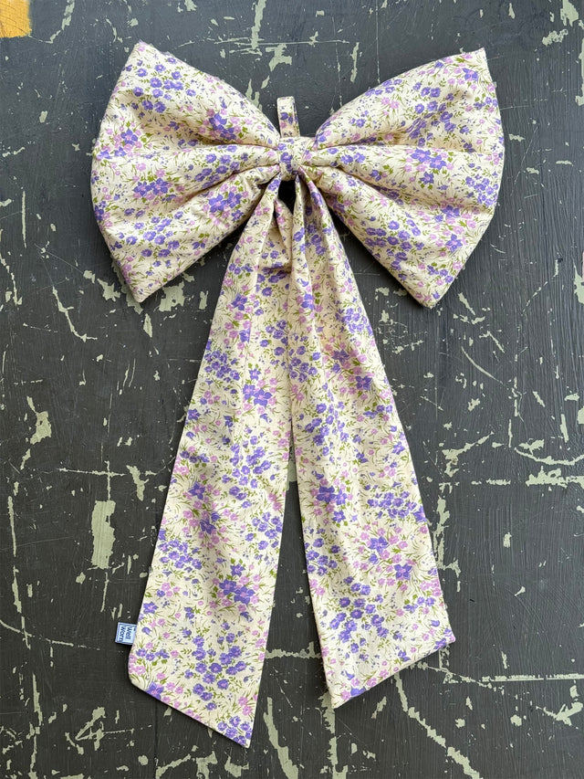 The Well Worn floral spring bow on table