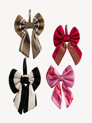 Four decorative bows in different colors on a white background