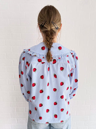 women in strawberry blouse back
