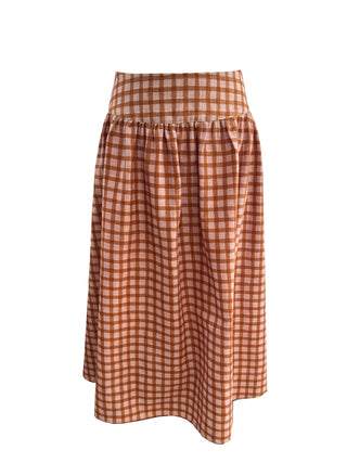 A high-waisted A-line skirt in a rust-orange and white gingham check pattern, shown against a plain white background.