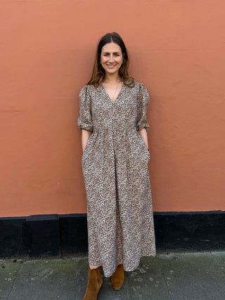 Front view of model wearing The Ottilie Dress – sustainable leopard print V-neck midi dress made from deadstock cotton.