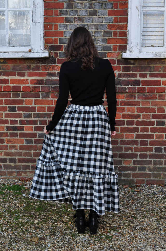 The Well Worn woman wearing gingham skirt with ruffle