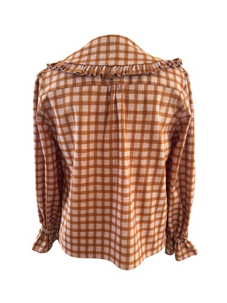 A long-sleeve gingham check blouse in brown and beige, featuring a ruffled collar and gathered cuffs, shown against a plain white background.