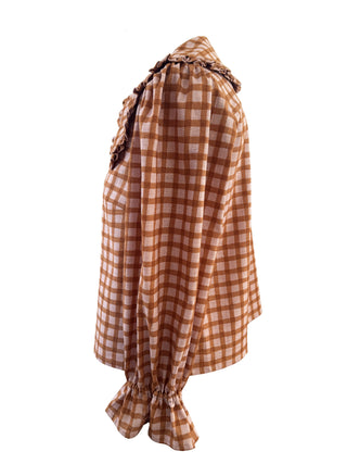 A brown and beige gingham blouse with a ruffled collar and gathered hem, displayed on a white background.