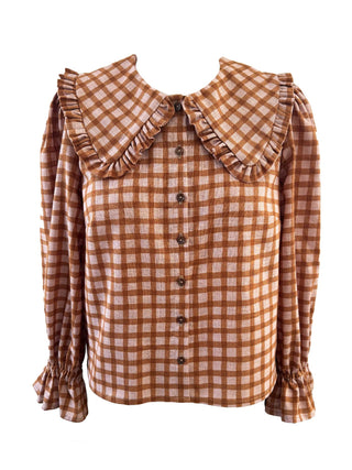 A long-sleeve button-up blouse with a large ruffled Peter Pan collar, featuring a brown and beige gingham check pattern and ruffled cuffs.