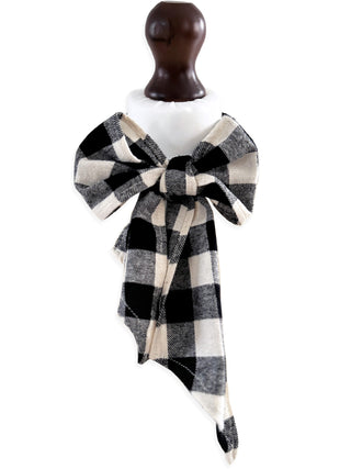 Black and white checkered scarf with a large bow on a mannequin against a white background