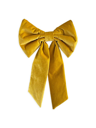 Mustard yellow velvet bow on a white background