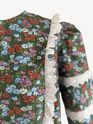 Floral patterned garment with lace trim on a white background