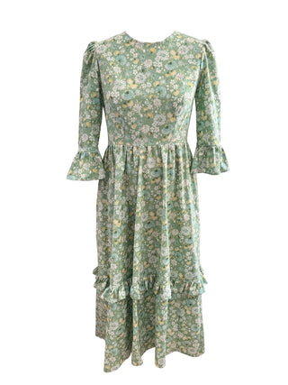A light green floral midi dress with three-quarter ruffled sleeves, a gathered waist, and a tiered ruffle hem, shown against a plain white background.