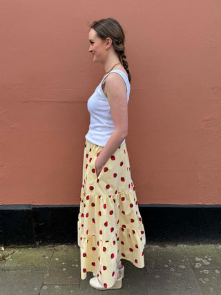 Lightweight cotton maxi skirt with gathered tiers, yellow stripes and strawberry motifs by The Well Worn