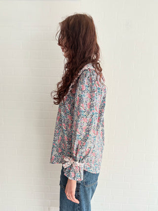 Sustainable vintage-inspired floral blouse with oversized collar and bow-detail cuffs
