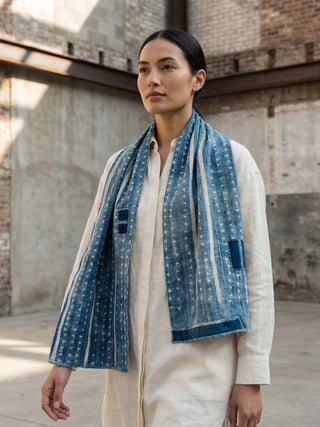 Woman wearing a blue patterned scarf in an urban setting