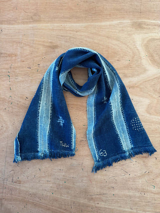Blue denim-style scarf on a wooden surface