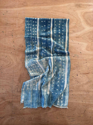 Blue and white patterned fabric on a wooden surface