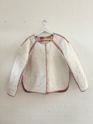 reversible quilted jacket on wall