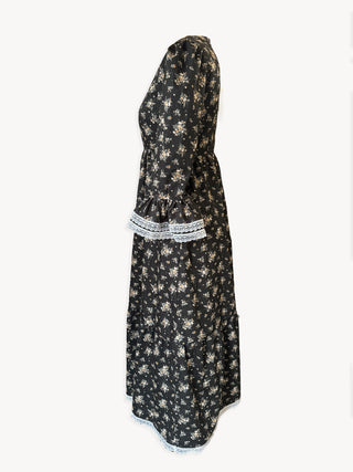 Black floral dress with lace trim on a white background