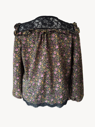 Floral blouse with lace trim on a white background