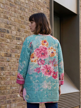 woman wearing floral quilted jacket back view