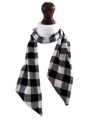 Black and white checkered scarf on a mannequin against a white background