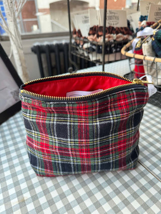 Plaid pouch with a red interior on a checkered tablecloth