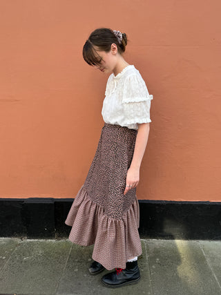 women wearing checked leopard skirt side view
