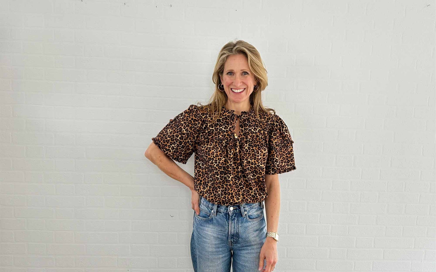The Well Worn women wearing leopard print top with jeans