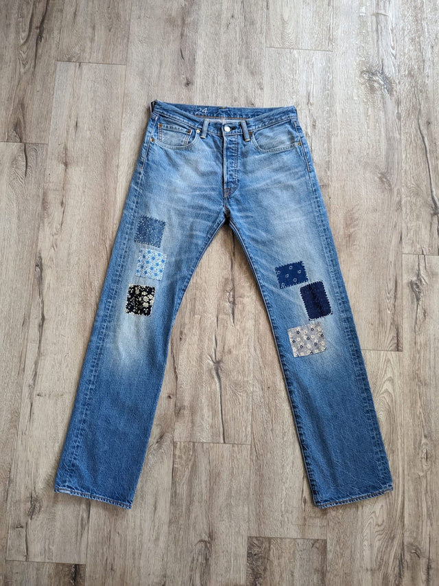 The Well Worn patched upcycled levi jeans on floor