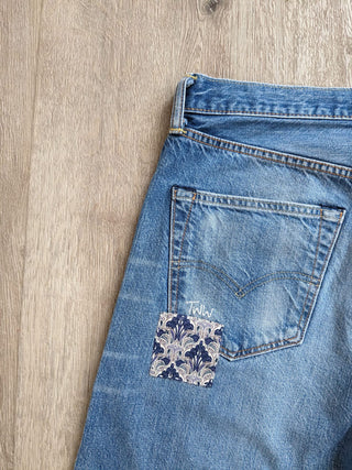 patched upcycled levi jeans on floor