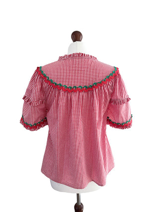 Back view of The Lucy Top in sustainable red gingham cotton blend, displayed on mannequin