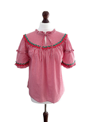 Front view of The Lucy Top in red gingham deadstock cotton with green and red crochet trim on mannequin